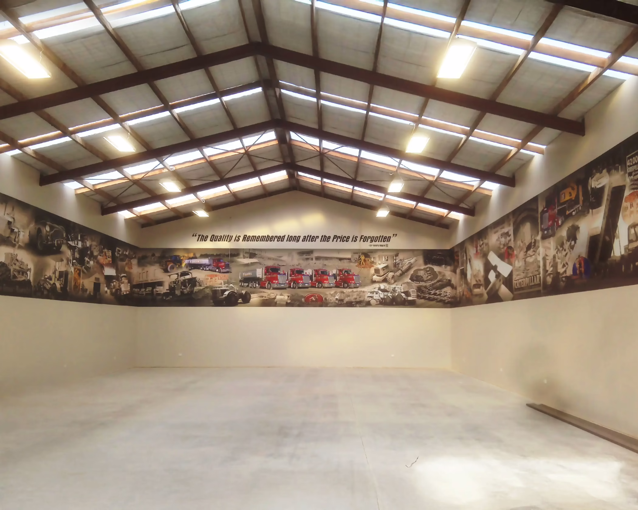 Large custom wall graphics with quote and vehicle montage for Faulks installed in garage space by Timaru Signs Graphix.