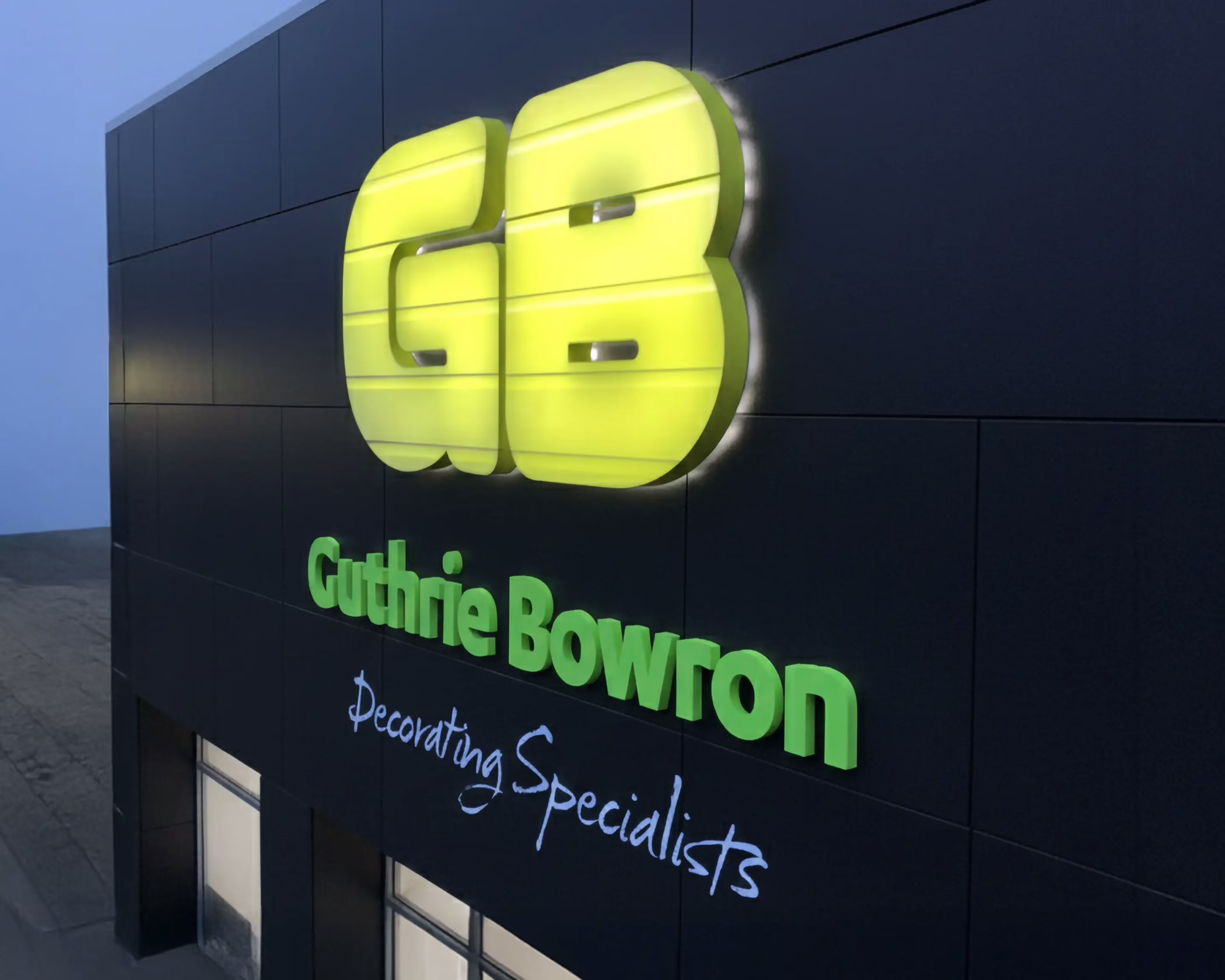 Illuminated 3D channel letter building fascia sign with green logo for Guthrie Bowron Decorating Specialists in Timaru.