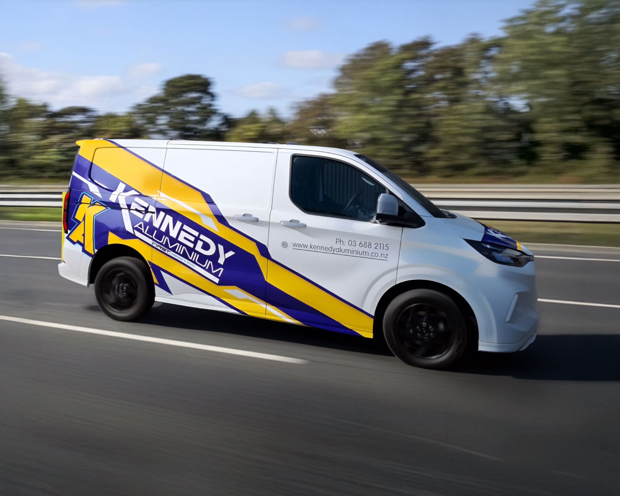 High-gloss commercial vehicle wrap for Kennedy Aluminium in Timaru, featuring blue and yellow graphics with a prominent stylized 'K A' and logo.