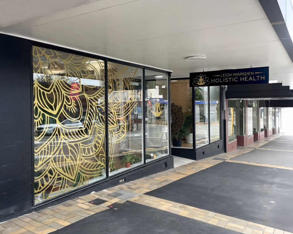 Leigh Marsden Holistic Health storefront featuring custom gold window graphics and black exterior sign by Timaru Signs.