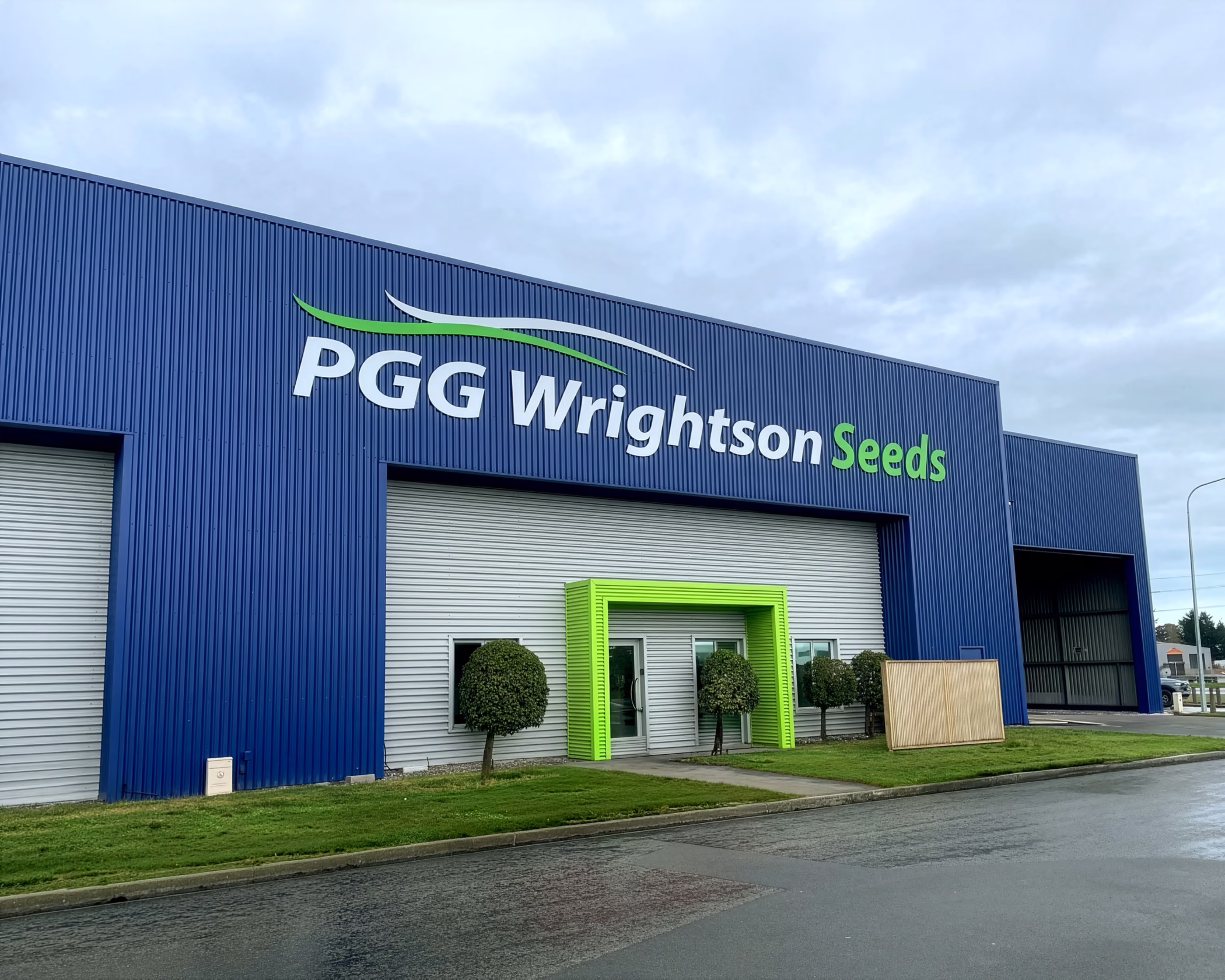 PGG Wrightson Seeds exterior building sign featuring a blue corrugated fascia with green and white corporate branding and logo.