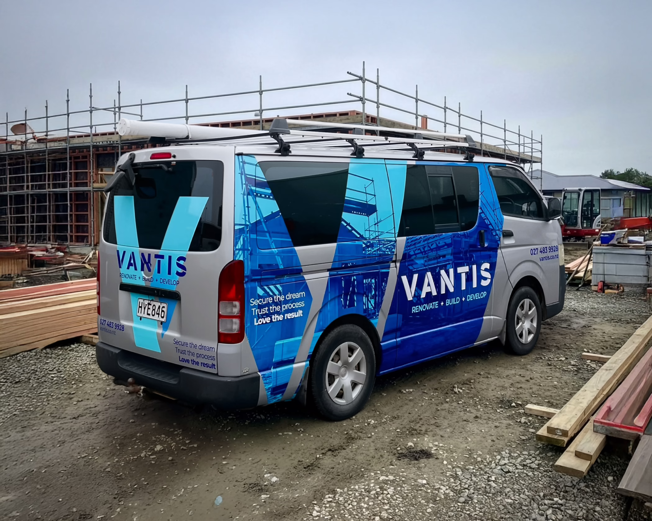 Custom vehicle wrap on a silver van for Vantis by Timaru Signs, featuring a blue geometric architectural design.