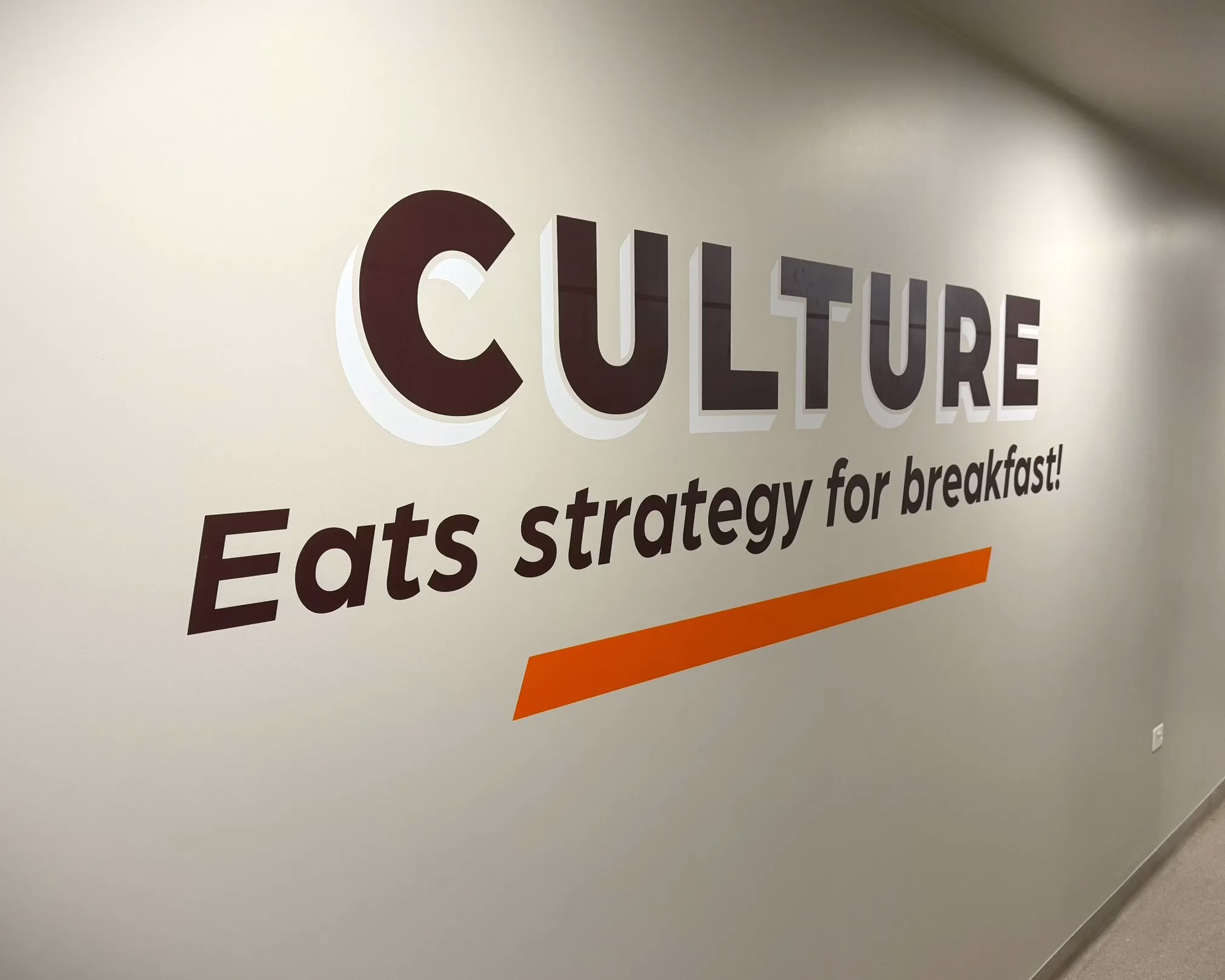 Wall graphics featuring "Culture Eats strategy for breakfast!" slogan installed in office by Timaru Signs Graphix.