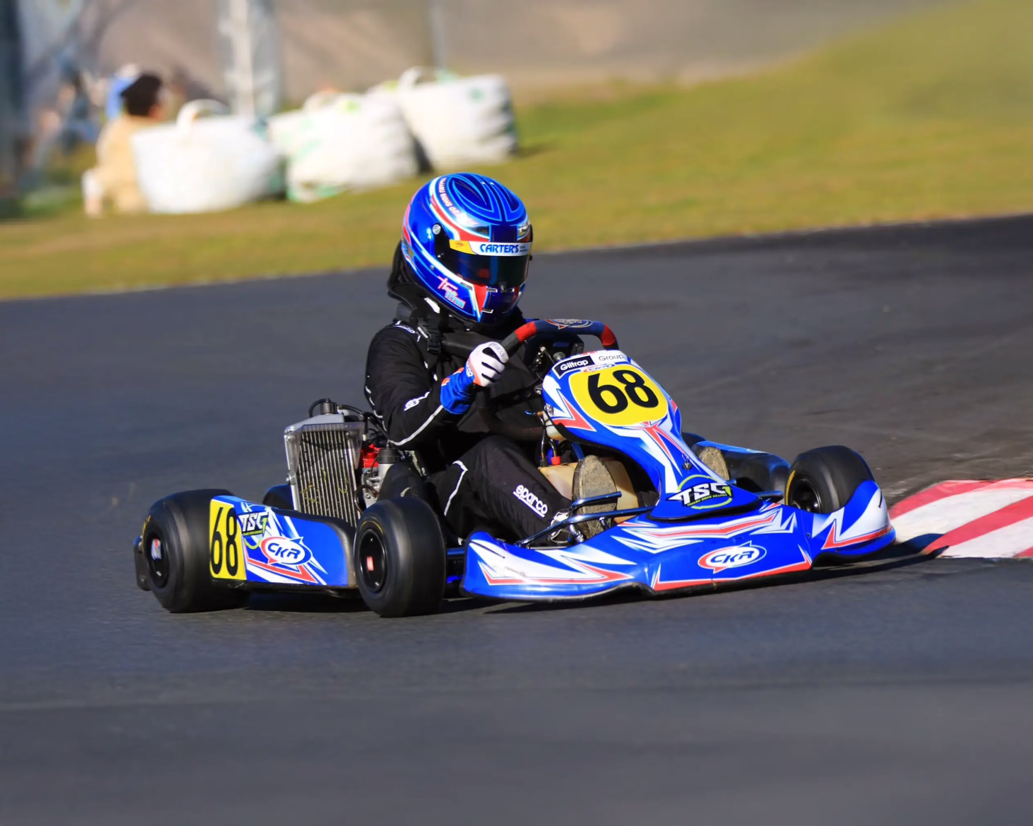 Blue, white, and red custom racing kart graphics featuring number 68 for driver Thomas Flynn.