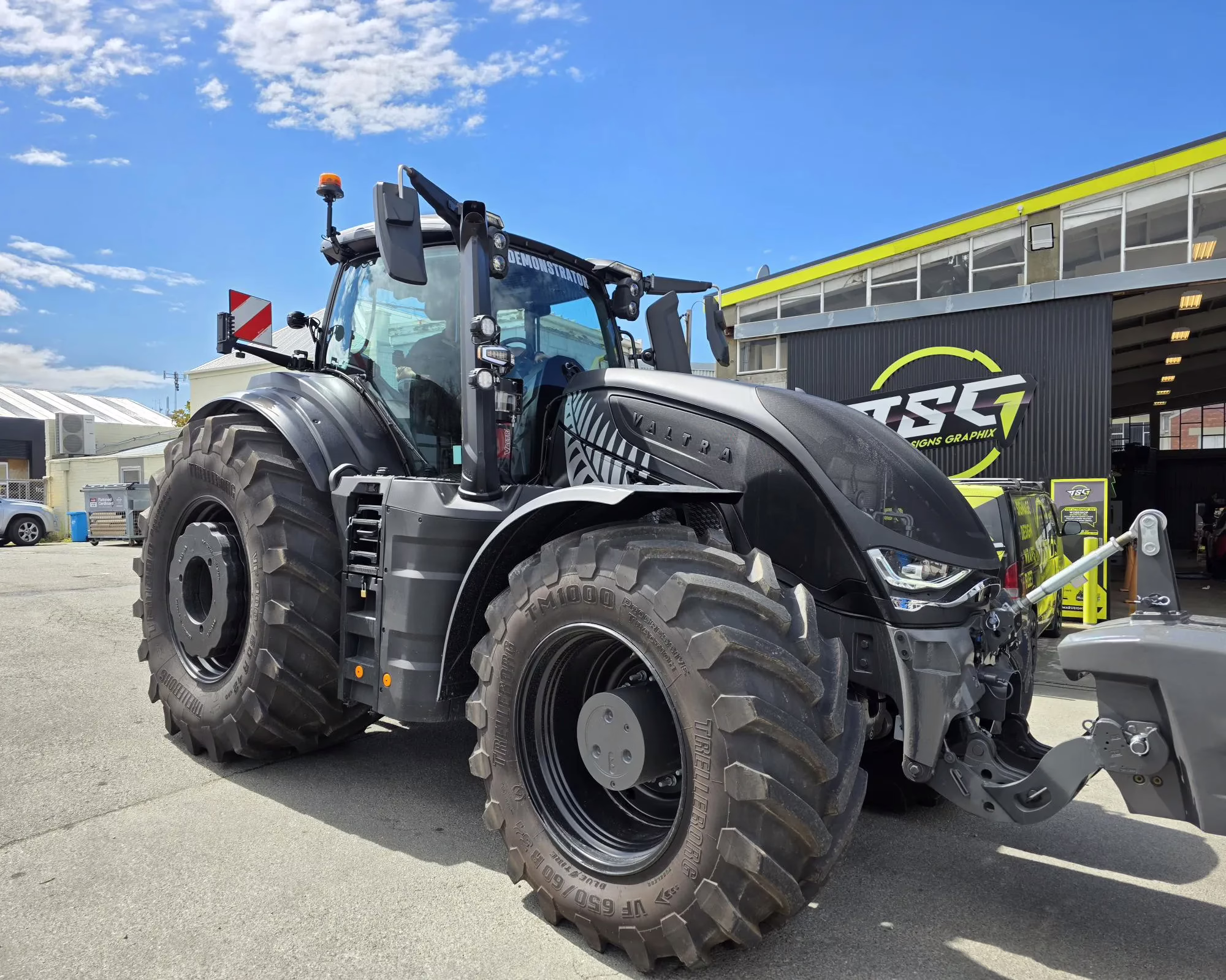 Matte black Valtra tractor with custom vehicle wrapping by Timaru Signs Graphix.
