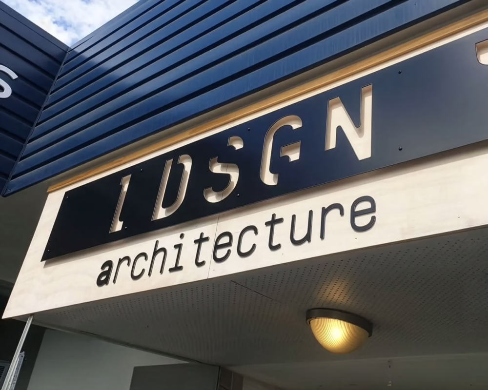 3D cut-out metal lettering sign reading IDSGN Architecture installed on an exterior building fascia by Timaru Signs Graphix.