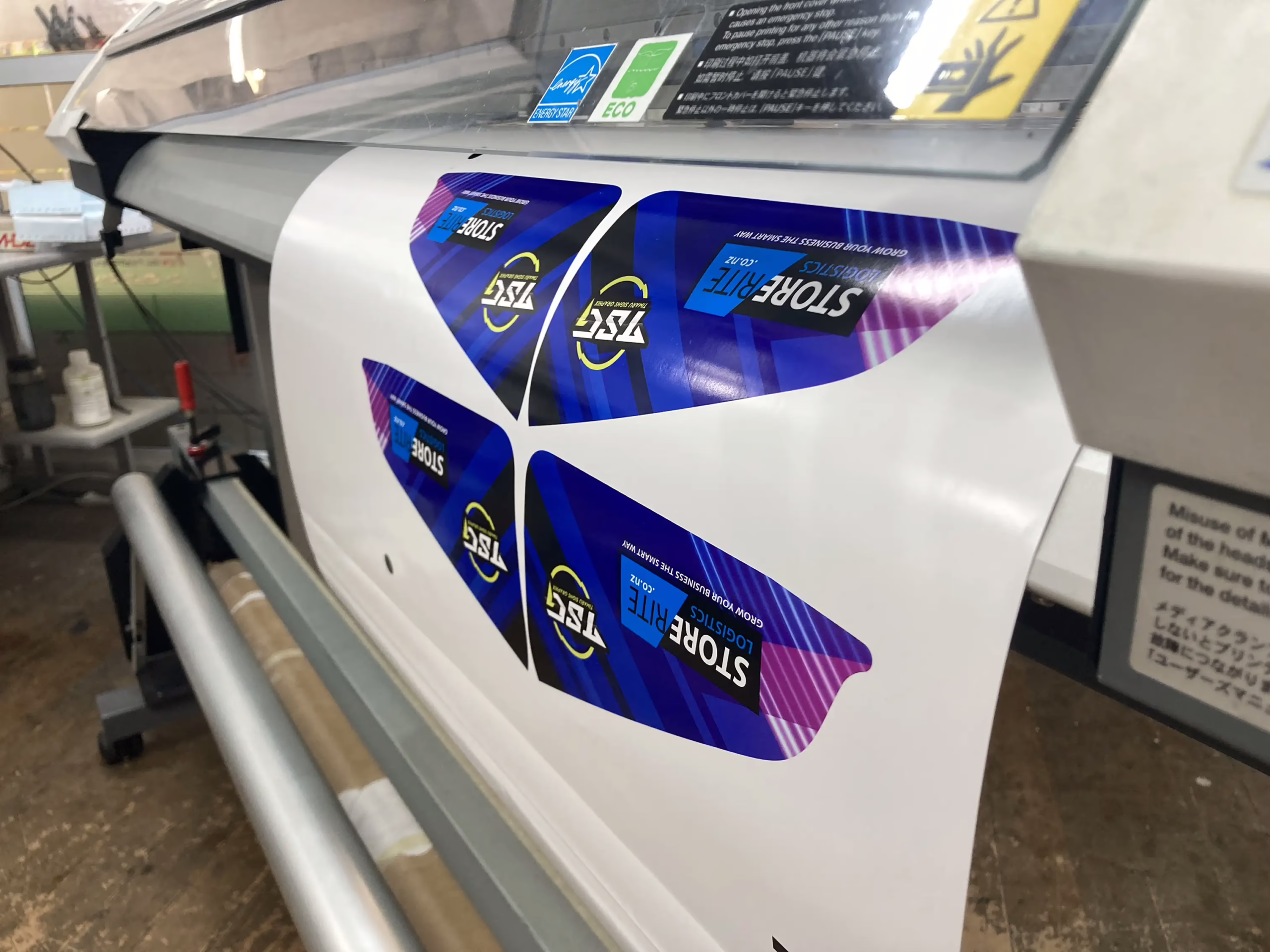 Large format commercial roll-to-roll eco-solvent printer printing vibrant graphics in a print shop