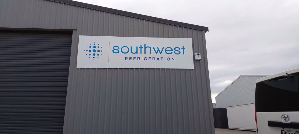 Custom exterior fascia building sign for Southwest Refrigeration with blue logo, created by Timaru Signs Graphix.