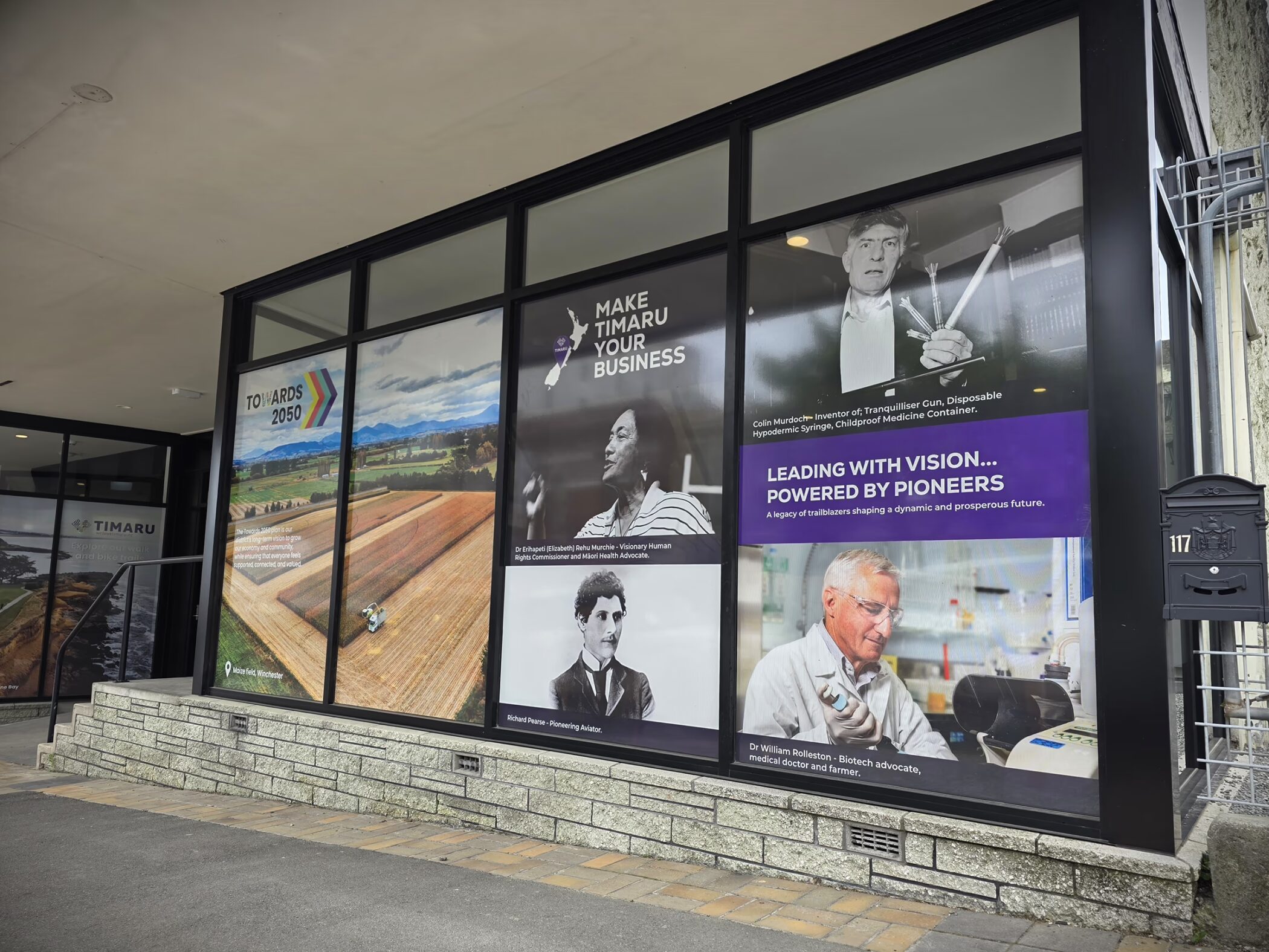 Custom window and wall graphics for Venture Timaru featuring pioneer profiles and "Make Timaru Your Business" branding.